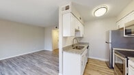 Located at 3314 Wickslow Dr in Wilmington, NC, this single-floor residence presents a clean, modern aesthetic throughout its well-designed layout. Light-toned hardwood-style flooring runs continuously through the living areas, bedrooms, and kitchen, creating a cohesive and inviting atmosphere.

The galley-style kitchen is a standout feature, outfitted with crisp white shaker cabinetry, granite countertops with subtle speckled detailing, a classic subway tile backsplash, and a full suite of stainless steel appliances including a refrigerator, electric range, and built-in microwave. A double-basin undermount sink with a brushed nickel faucet completes the functional workspace.

The living area is bright and open, benefiting from multiple windows dressed with white blinds that allow natural light to fill the space. A sliding glass door leads to an outdoor deck, extending the living space and providing views of the surrounding exterior. The neutral warm-gray wall tones provide a versatile backdrop throughout.

Bedrooms are comfortably sized with the same continuous flooring and neutral walls, offering a calm and restful environment. The bathroom features a full soaking tub with a tiled surround in crisp white, finished with brushed nickel hardware. Overall, this residence delivers a refreshed, move-in-ready feel with thoughtful updates throughout.