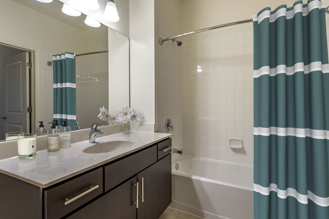 Newly renovated apartment homes feature baths with espresso cabinetry, grey quartz countertops, and hard surface flooring - Avalon Huntington Station