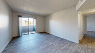 Located at 8600 Starboard Dr in Las Vegas, NV, this 3-bedroom, 2-bathroom unit offers a well-designed single-floor layout with consistent light wood-style flooring throughout. The open living area is bright and welcoming, featuring a sliding glass door that leads to a private balcony with outdoor views, and a textured ceiling that adds character to the space.

The kitchen is a standout feature, boasting white shaker cabinetry, light quartz countertops, a grey subway tile backsplash, and a full suite of stainless steel appliances including a refrigerator, dishwasher, and range. A skylight overhead fills the kitchen with natural light, enhancing its clean, modern aesthetic.

The spacious primary bedroom includes mirrored sliding closet doors, adding depth and light to the room. The two bathrooms are finished in white with tile surrounds — one featuring a tub/shower combo and the other a walk-in shower — both with white vanities and wood-look flooring.

A dedicated laundry area houses a full-size side-by-side washer and dryer. Additional rooms include a ceiling fan-equipped dining area adjacent to the kitchen and a hallway closet for extra storage. The unit's neutral palette and updated finishes create a clean, move-in-ready atmosphere throughout.