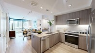 Located in the heart of Midtown Atlanta, this well-appointed one-bedroom, one-bathroom residence offers a thoughtfully designed open-concept layout with contemporary finishes throughout. Light hardwood flooring flows seamlessly across the entire living space, complemented by recessed lighting and a bright, airy atmosphere.

The modern kitchen serves as a central hub, featuring sleek flat-panel cabinetry in warm wood tones, stainless steel appliances including a gas range, built-in microwave, dishwasher, and refrigerator. A marble-style backsplash adds elegance, while the peninsula island with seating provides both additional prep space and casual dining functionality.

The living room is anchored by expansive floor-to-ceiling windows offering sweeping views of the Atlanta skyline, flooding the space with natural light. A dedicated dining area completes the open living zone.

The bedroom is a serene retreat featuring a tray ceiling with ceiling fan, large windows with access to a private balcony, and generous closet storage. The bathroom impresses with large-format marble-style tile flooring, a floating wood vanity with an integrated sink, a glass-enclosed shower, and refined fixtures throughout. This residence delivers an elevated urban living experience in one of Atlanta's most vibrant neighborhoods.