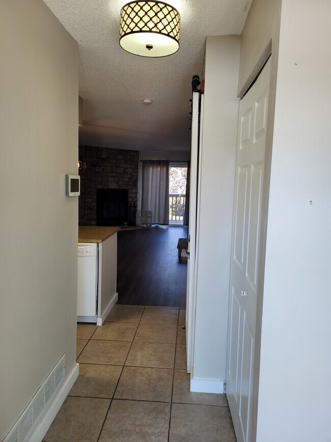Entry way with kitchen access on the left, storage closet on the right. - 1228 S Idalia St