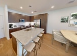 This contemporary residence in McKinney, Texas, offers 1520 square feet of thoughtfully designed living space across two floors. The home boasts three bedrooms, including a generous 190-square-foot primary suite, and four well-appointed bathrooms. The ground floor spans 570 square feet, while the upper level provides 950 square feet of space.

The interior showcases a blend of modern aesthetics and practical features. Light-toned wood flooring runs throughout the main living areas and bathrooms, complemented by plush carpeting in the bedrooms. Large windows with blinds allow ample natural light to flood the rooms, creating a bright and airy atmosphere.

The kitchen is a highlight, featuring sleek wood cabinetry, stainless steel appliances, and granite countertops. A spacious living room offers an ideal space for relaxation and entertainment. The bathrooms are equipped with modern fixtures, including glass-enclosed showers and ample storage.

Practical amenities include a dedicated laundry room with full-sized appliances and built-in cabinetry. The home also features multiple closets, including walk-in options, providing abundant storage space. Ceiling fans in the bedrooms and living areas ensure comfort year-round.

The property's layout includes two hallways for easy navigation between rooms, and a staircase connecting the two floors. This well-designed home on Pepperidge St combines style, comfort, and functionality, making it an attractive option in the desirable McKinney area.