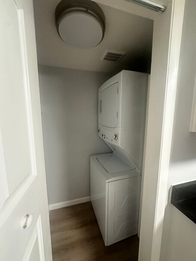 Stacked washer and dryer just off the kitchen. - 12170 Huron St