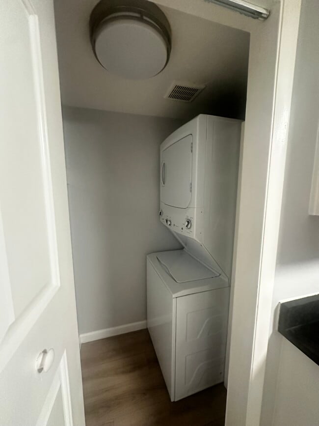 Stacked washer and dryer just off the kitchen. - 12170 Huron St