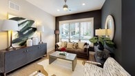 Located on E Independence Blvd in Charlotte, NC, this thoughtfully designed single-floor residence blends contemporary style with functional living. The entry hall features rich hardwood-style flooring and striking dark navy panel doors that set a sophisticated tone throughout.

The kitchen is a standout, outfitted with crisp white shaker cabinetry, dark countertops, black hardware, and stainless steel appliances. A dedicated wet bar with wine storage and under-cabinet lighting adds an elevated entertaining touch, complemented by a sliding barn door detail nearby.

The dining area benefits from abundant natural light streaming through large windows with outdoor views, centered around a round wooden table in a dramatic dark-accented space. The living room continues this bold aesthetic with a dark feature wall, recessed lighting, ceiling fan, and ample room for relaxed gatherings.

The primary bedroom offers a serene retreat with floor-to-ceiling windows, a four-poster bed frame, and a spacious walk-in closet featuring built-in shelving and double hanging rods. An additional bedroom showcases a charming dark accent wall with curated artwork and natural light. The bathroom is clean and modern, with white cabinetry, dark countertops, a glass-enclosed shower, and large-format tile flooring.