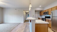 Located at 941 Taylor Station Rd in Columbus, OH, this single-floor, 3-bedroom, 2-bathroom home offers a well-designed layout with a comfortable, functional living experience. The open-concept living, dining, and kitchen area serves as the heart of the home, featuring light hardwood-style flooring, neutral gray walls, and recessed lighting. The kitchen is equipped with warm-toned wood cabinetry, stainless steel appliances including a refrigerator, gas range, and built-in microwave, and a large island topped with elegant marble-style countertops. Stylish pendant lighting above the island adds a polished touch. A pantry and dedicated utility and laundry rooms enhance everyday convenience. The three bedrooms are carpeted and filled with natural light from windows with blinds. The spacious primary bedroom offers generous closet space, while additional bedrooms each feature their own closets with sliding doors. The bathrooms are clean and modern, with one featuring a glass-enclosed walk-in shower. With eight closets throughout, storage is plentiful. A private patio completes the home, providing outdoor space for relaxation. This well-appointed residence balances practicality and comfort in a thoughtfully organized floor plan.