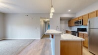 Located at 941 Taylor Station Rd in Columbus, OH, this single-floor, 3-bedroom, 2-bathroom home offers a well-designed layout with a comfortable, functional living experience. The open-concept living, dining, and kitchen area serves as the heart of the home, featuring light hardwood-style flooring, neutral gray walls, and recessed lighting. The kitchen is equipped with warm-toned wood cabinetry, stainless steel appliances including a refrigerator, gas range, and built-in microwave, and a large island topped with elegant marble-style countertops. Stylish pendant lighting above the island adds a polished touch. A pantry and dedicated utility and laundry rooms enhance everyday convenience. The three bedrooms are carpeted and filled with natural light from windows with blinds. The spacious primary bedroom offers generous closet space, while additional bedrooms each feature their own closets with sliding doors. The bathrooms are clean and modern, with one featuring a glass-enclosed walk-in shower. With eight closets throughout, storage is plentiful. A private patio completes the home, providing outdoor space for relaxation. This well-appointed residence balances practicality and comfort in a thoughtfully organized floor plan.