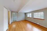 Located at 2820 US-11 in La Fayette, NY, this well-maintained one-bedroom, one-bathroom residence offers a practical and comfortable layout across a single floor. The living area features warm hardwood flooring, neutral taupe walls, and exposed ceiling beams that add a touch of architectural character. Multiple windows dressed with blinds allow natural light to fill the space, while a wall-mounted air conditioning unit and baseboard heating ensure year-round comfort. The spacious primary bedroom is finished with plush wall-to-wall carpeting and benefits from the same baseboard heating system, creating a cozy retreat. Three closets throughout the unit provide generous storage options, including one that houses the electrical panel. The bathroom is cleanly finished with white tile flooring, a warm wood-toned vanity with a white countertop, a large mirror, and a full soaking tub with shower. The overall layout is efficient and well-organized, with a smooth flow between the living, sleeping, and utility areas. The unit's clean, move-in-ready condition and practical amenities make it a solid and functional living space in a quiet Central New York setting.
