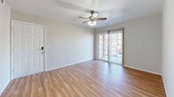 This 790 square foot single-story home in Ozark, MO offers a practical layout with 2 bedrooms and 2 bathrooms. The open-concept living area is highlighted by gleaming hardwood floors and a ceiling fan, creating a spacious feel. The modern kitchen features honey-colored wood cabinetry, white appliances, and ample counter space. The primary bedroom, measuring 170 square feet, provides a generous retreat with plush carpeting and a large window for natural light. Both bathrooms are well-appointed, one with a glass-enclosed shower and the other with a vanity and mirror. The property includes a walk-in closet with built-in shelving for added storage. Throughout the home, neutral walls and a mix of hardwood and carpeted floors create a cohesive, contemporary ambiance. French doors in the living area lead to an outdoor space, extending the living area. This efficient home balances comfort and functionality in its design.