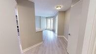 Located at 1243 11th Ave SW in Calgary, AB, this 2-bedroom, 2-bathroom unit offers a thoughtfully designed layout that maximizes every square foot. Light wood-tone laminate flooring flows consistently throughout the space, complemented by neutral warm-grey walls and white trim that create a clean, cohesive aesthetic.

The living area receives natural light through large corner windows fitted with roller blinds, and features baseboard heating for year-round comfort. A pass-through counter connects the living space to the kitchen, which is equipped with stainless steel appliances — including a refrigerator, electric range, and over-the-range microwave — set against a tile backsplash with dark wood cabinetry and white countertops.

Both bedrooms are well-proportioned and bright, each fitted with ceiling fans and light flooring. The primary bedroom includes access to a dedicated closet. A hallway connects all rooms and reveals an in-unit stacked washer and dryer, adding significant convenience.

The two bathrooms are consistently finished with tile flooring, wood-tone vanity cabinetry, white countertops, and tub-shower combinations with curved curtain rods. A textured ceiling throughout the unit adds a traditional finish to this modern, move-in ready space.