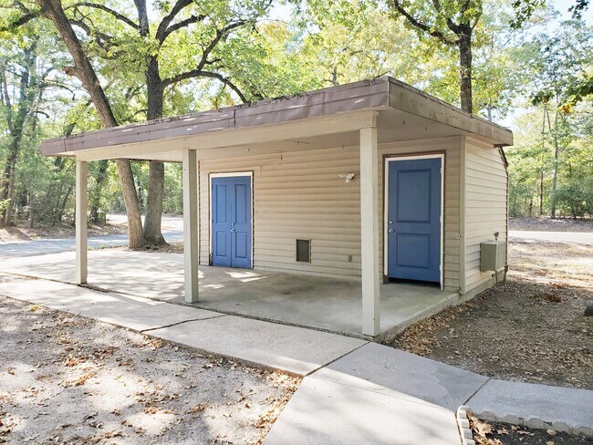 Covered carport contains two large storage areas, extra fridge and a/c unit in one storage area - 28700 Gumwood Ct