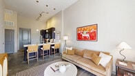 Located in the vibrant East Nashville neighborhood, this well-designed one-bedroom, one-bathroom unit offers a thoughtful layout across a single floor. The open-concept living and kitchen area is anchored by dramatically tall ceilings that lend a sense of spaciousness well beyond its compact footprint. Polished concrete floors run throughout the main living area, adding an industrial-modern aesthetic.

The kitchen is outfitted with dark cabinetry, white countertops, a classic subway tile backsplash, and a full suite of stainless steel appliances including a refrigerator, electric range, microwave, and dishwasher. A peninsula with bar seating provides casual dining space and connects seamlessly to the living room, which benefits from large windows that invite abundant natural light.

The bedroom is a calm, well-proportioned retreat with carpet flooring, large windows with natural light, and a dedicated closet. The bathroom features dark cabinetry matching the kitchen, a white vanity countertop, tile flooring, and a full tub-shower combination. A private entry door and separate closet space complete the unit. The overall ambiance is modern and urban, well-suited for those seeking a contemporary lifestyle in one of Nashville's most dynamic neighborhoods.