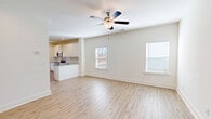 Located in Calhoun, Georgia, this two-story home offers a thoughtfully designed layout across two floors. The main level provides a generous living footprint, featuring an open-concept living and dining area bathed in natural light from multiple windows. A ceiling fan adds comfort to the airy great room, which flows seamlessly into a well-equipped kitchen outfitted with white shaker-style cabinetry, granite countertops, subway tile backsplash, stainless steel appliances including a range, microwave, dishwasher, and refrigerator, and a peninsula with a sink — ideal for both cooking and casual dining. A pantry and dedicated laundry room add practical convenience, while an attached garage completes the main level.

The home includes three bedrooms, each featuring warm wood-look flooring, crisp white walls, and natural light. The primary bedroom is a comfortable retreat with a ceiling fan and direct access to its own bathroom and closet. All three bathrooms are finished with granite-topped white vanities and wood-look flooring; bathrooms include either a glass-enclosed walk-in shower or a tub/shower combination. Upstairs, a versatile loft provides additional flexible living space. Throughout the home, light hardwood-style flooring, clean white trim, and a neutral palette create a cohesive, modern aesthetic.