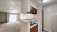 Located at 1401 SW B Ave in Lawton, Oklahoma, this 2-bedroom, 2-bathroom single-floor residence offers a functional and straightforward layout designed for comfortable everyday living. The living room is generously sized, featuring wall-to-wall carpeting, a textured ceiling, and a sliding glass door that opens to an outdoor patio, bringing in natural light and providing convenient exterior access. A kitchen counter with a pass-through connects the living and kitchen areas, contributing to an open feel.

Both bedrooms are carpeted and feature windows that allow natural light to fill each room. The primary bedroom is a comfortable size and includes a dedicated closet. The second bedroom also benefits from natural light through its window and has its own closet.

Each of the two full bathrooms is appointed with a tiled tub and shower combination, a toilet, and a vanity. The bathrooms feature wood-look flooring and textured ceilings consistent with the rest of the home. Two hallways connect the various rooms, contributing to a logical and easy-to-navigate floor plan.

Throughout the unit, neutral wall tones and consistent carpet create a cohesive, move-in-ready aesthetic. The overall layout makes efficient use of the available space, making this a practical and well-organized residence.