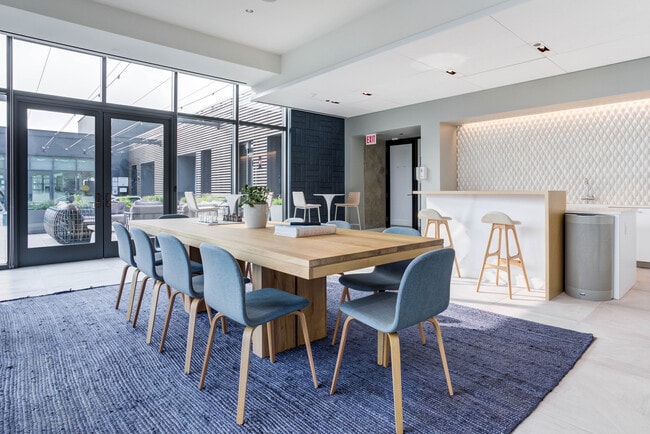 A bright, modern space made for gathering, working, or relaxing in style. - Emme