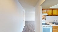 Step into a world of possibilities in this meticulously designed 860 sq ft apartment. The open-concept living area welcomes you with warm, wood-like flooring that flows seamlessly throughout, creating a sense of spaciousness and harmony. Large sliding glass doors flood the space with natural light, offering a connection to the outdoors and the promise of lazy afternoons basking in the sun.

The heart of this home is the charming kitchen, where honey-toned wood cabinetry meets a stylish mosaic backsplash, creating a perfect blend of traditional warmth and modern flair. Ample counter space and updated appliances make this an ideal setting for culinary adventures or casual entertaining.

Both bedrooms boast generous proportions, with the primary bedroom offering a spacious 150 sq ft retreat. Ceiling fans add a touch of comfort and style, while cleverly designed closet spaces ensure that organization is effortless.

The crisp, white bathroom exudes cleanliness and simplicity, featuring a full-size tub perfect for relaxing soaks after long days. Throughout the apartment, neutral tones provide a blank canvas for your personal style to shine.

This home isn't just a space; it's an opportunity to create the lifestyle you've always dreamed of. Whether you're a first-time buyer, downsizing, or seeking an excellent investment, this property offers the perfect foundation for your next chapter. Embrace the potential, make it your own, and start living your aspirations today.