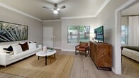 Located at 1800 W Granger St in Broken Arrow, Oklahoma, this single-story, one-bedroom, two-bathroom home offers a well-designed layout that maximizes every square foot. The open-concept living and dining area is anchored by light wood-style flooring, crown molding, and a ceiling fan, while a large window invites natural light and outdoor views, creating a bright and welcoming atmosphere.

The kitchen is thoughtfully designed in a galley style, featuring white upper cabinets, gray lower cabinets, white quartz countertops, and a full suite of stainless steel appliances, including a range, microwave, dishwasher, and refrigerator. The adjacent dining area provides a seamless transition between cooking and entertaining spaces.

The carpeted bedroom is generously sized and features a ceiling fan, a large window with outdoor views, and access to a closet. The two bathrooms are finished with quartz countertops, undermount sinks, and light wood-style tile flooring. One bathroom includes a tub-shower combination with clean white surround.

A dedicated laundry area houses an in-unit Whirlpool top-load washer and includes overhead wire shelving for added storage. Neutral warm-gray tones throughout the home create a cohesive, modern aesthetic that is both functional and inviting.