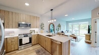 Located at 5424 Old Orchard Rd in Skokie, IL, this thoughtfully designed one-bedroom, one-bathroom residence offers a modern, cohesive aesthetic throughout its efficiently utilized single-floor layout. Light hardwood flooring flows seamlessly across the space, tying together each room with warmth and continuity.

The open-concept kitchen and living area serves as the heart of the home. The kitchen is outfitted with flat-front light wood cabinetry, stainless steel appliances including a gas range, microwave, refrigerator, and dishwasher, and a crisp white quartz countertop. A peninsula with seating for three is illuminated by a sleek multi-pendant light fixture, making it ideal for both casual dining and entertaining.

The living room is bright and airy, anchored by a large sliding glass door that invites abundant natural light and provides outdoor access. The serene, neutral palette creates a calm and welcoming atmosphere.

The bedroom is a comfortable retreat featuring a window with outdoor views, a dedicated closet, and clean white panel doors. The bathroom is finished with white subway tile in the tub/shower surround, a wood-toned vanity, and light hardwood flooring, maintaining the space's consistent modern style. The overall ambiance is clean, contemporary, and move-in ready.