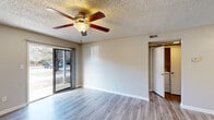 Located at 1108 Saint Andrews Dr in Wilmington, NC, this well-appointed one-bedroom, one-bathroom residence offers a functional and comfortable layout across a single floor. The living room serves as the heart of the home, featuring light-toned luxury vinyl plank flooring, a ceiling fan with light fixture, a textured ceiling, and a sliding glass door that fills the space with natural light and provides direct access to the outdoors. The galley-style kitchen is efficiently designed with crisp white shaker cabinetry, stone-patterned countertops, stainless steel appliances including a refrigerator and electric range, a built-in dishwasher, and a single-basin sink — all complemented by matching LVP flooring and a round flush-mount ceiling light. The bedroom offers plush carpeting, a ceiling fan, a window with exterior views, and a dedicated closet with a hanging rod for ample storage. The bathroom includes a clean, white tub and shower surround with a built-in towel bar. A hallway connects the rooms, maintaining a smooth flow throughout. Neutral tones and consistent finishes give this residence a cohesive, move-in-ready feel.
