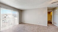 Located at 9300 Orchard Blvd in Midwest City, Oklahoma, this one-bedroom, one-bathroom unit offers a practical and well-organized single-floor layout. The combined living, dining, and kitchen area forms the heart of the unit, featuring neutral-toned walls, a textured ceiling, and plush wall-to-wall carpeting in the living and dining spaces. A sliding glass door with vertical blinds opens to a balcony, allowing natural light to fill the room and providing outdoor views of the surrounding neighborhood.

The galley-style kitchen is efficiently designed with white cabinetry lining both sides, laminate countertops, a stainless steel sink, and white appliances including an electric range and refrigerator. Wood-look vinyl flooring runs throughout the kitchen, adding a clean, durable finish.

The bedroom is a comfortable, well-proportioned space with soft carpet underfoot, a ceiling fan with a light fixture, and a window that brings in additional natural light. Two closets provide ample storage, and direct access to the hallway connects seamlessly to the rest of the unit.

The bathroom is appointed with a full tub-shower combination, a vanity with storage cabinetry above, and wood-look flooring. A dedicated utility room adds functional value to the overall layout. Textured ceilings are consistent throughout the unit.