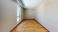 Located at 520 2nd St SE in Minneapolis, MN, this efficient studio unit offers a thoughtfully arranged single-floor layout that maximizes every square foot. The open-plan living, dining, and kitchen area serves as the heart of the space, where light wood laminate flooring flows seamlessly throughout, creating a warm and cohesive aesthetic. Exposed industrial-style ductwork runs along the ceiling, lending the unit a modern loft character that complements the track lighting overhead.

The kitchen is well-appointed with warm-toned wood cabinetry stacked to the ceiling for ample storage, a full suite of black appliances including a refrigerator, electric range, built-in microwave, and dishwasher, and a single-basin sink with a window nearby. The living area benefits from a large window that brings in natural light and views of the surrounding neighborhood.

The entry hallway is flanked by two closets with sliding mirrored and solid doors, offering generous storage for a unit of this size. The bathroom is clean and functional, featuring a full soaking tub with an overhead shower, a curved curtain rod, tile flooring, and neutral beige walls. The overall ambiance is practical and urban, making this unit a well-suited option for those seeking a compact, efficient living space in Minneapolis.