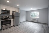 Located at 216 Parkway Drive in Williamsburg, Virginia, this single-floor unit offers a clean, modern layout with contemporary finishes throughout. The open-concept living and kitchen area is anchored by light wood-look luxury vinyl plank flooring, which extends seamlessly through the entire space, creating a cohesive and easy-to-maintain environment.

The kitchen is thoughtfully designed with crisp white shaker-style cabinetry, granite-look countertops, and a full suite of stainless steel appliances, including a refrigerator, gas range, and over-the-range microwave. Recessed lighting illuminates the space efficiently, while the neutral gray-blue wall tones complement the white cabinetry and light flooring.

The open living area provides generous room for flexible furnishing arrangements, with smooth, neutral-painted walls and recessed ceiling lights adding to the bright, airy atmosphere. A built-in closet with shelving and hanging space is conveniently located just off the main living area, providing ample storage.

The bathroom features the same light vinyl plank flooring as the rest of the unit, soft gray walls, and clean, functional fixtures. The space is straightforward and well-maintained, reflecting the updated character found throughout the unit. Overall, the space presents a fresh, move-in-ready environment well-suited for comfortable everyday living.