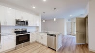 This contemporary 1270 square foot home in Glen Allen, VA offers a thoughtful layout with 3 bedrooms and 3 bathrooms on a single floor. The heart of the home is an open-concept kitchen and living area, showcasing a sleek design with white cabinetry, stainless steel appliances, and granite countertops. The kitchen's L-shaped layout maximizes efficiency and includes a convenient island for additional workspace and casual dining.

Throughout the home, a mix of warm wood-look flooring and plush carpeting creates a cozy yet modern ambiance. Large windows in the bedrooms and living areas flood the space with natural light, while providing views of the surrounding neighborhood. Each bedroom is equipped with a ceiling fan for comfort and features ample closet space.

The bathrooms are designed with functionality in mind, featuring clean lines, granite countertops, and modern fixtures. The primary bathroom boasts a double vanity for added convenience. The home also includes dedicated closet spaces, ensuring plenty of storage options for residents.

A notable feature is the glass door leading to an outdoor space, seamlessly connecting the interior with the exterior and expanding the living area. The neutral color palette throughout the home provides a blank canvas for personal styling, making this property an ideal choice for those seeking a contemporary living space with all the modern amenities.