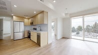 This contemporary penthouse apartment, located at 7050 Hawthorn Ave in Los Angeles, offers a generous 950 square feet of living space on a single floor. The property boasts four bedrooms, including a spacious 190 square foot primary bedroom, and three full bathrooms. The open-concept design seamlessly integrates the kitchen and living areas, creating a fluid and airy atmosphere. 

Throughout the apartment, light wood flooring adds warmth and complements the crisp white walls, enhancing the sense of space and light. Large windows in the living areas and bedrooms flood the rooms with natural light and provide stunning city views. The kitchen features modern light wood cabinetry, stainless steel appliances, and a sleek white backsplash, offering both style and functionality.

Bedrooms are well-proportioned, with ample closet space and continuation of the light, airy design aesthetic. Bathrooms are fitted with glass-enclosed showers, modern fixtures, and clean lines, maintaining the contemporary feel of the home. Recessed lighting throughout adds to the modern ambiance, while providing adjustable illumination options.

This penthouse combines the best of urban living with a thoughtful layout and high-end finishes, making it an ideal residence in the heart of Los Angeles.