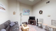 Situated on South Court Street in the heart of Athens, Ohio, this single-floor unit offers a well-organized layout with distinct living, dining, kitchen, and sleeping areas. The open-concept kitchen is a standout feature, boasting warm wood cabinetry, stainless steel appliances including a refrigerator, microwave, and range, generous countertop space, and a raised breakfast bar with seating for three — ideal for casual dining. A skylight overhead fills the kitchen with natural light, adding to the airy feel of the space. The living area is carpeted and comfortably sized, featuring notably tall ceilings and a skylight that enhances the sense of openness. Tile flooring near the entryway provides a clean transition into the space. Two bedrooms offer carpeted floors, large windows with views of the surrounding streetscape, and ample room for personal furnishings. The full bathroom includes a combination tub and shower, a vanity with storage, and tile flooring. Throughout the unit, neutral wall tones create a versatile backdrop. The prime downtown Athens location places residents within close proximity to local shops, dining, and Ohio University.
