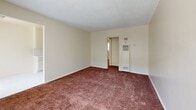 This 500 square foot apartment in Los Angeles, CA offers a practical living space with two bedrooms and one bathroom. The single-floor layout maximizes efficiency, with the primary bedroom boasting a generous 190 square feet. The living area showcases wall-to-wall carpeting in a warm brown hue, creating a cozy atmosphere throughout. Large windows in the main living space and bedrooms allow for ample natural light, enhancing the sense of openness.

The kitchen, while compact, is well-equipped with essential appliances and ample cabinet space in a neutral cream color. White tile backsplash and a double sink provide functionality and easy maintenance. The bathroom features a sliding glass shower door and additional storage.

Notable elements include a ceiling fan in one of the bedrooms, mirrored closet doors adding depth to the space, and vertical blinds for privacy and light control. The neutral color palette of cream walls and white ceilings throughout maintains a bright, clean appearance. This apartment offers a practical and comfortable living solution in a bustling urban setting.