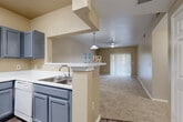 This single-story, 3-bedroom, 2-bathroom home in Round Rock, Texas offers a well-designed layout that balances functionality and comfort. The entry foyer opens directly to the kitchen, which features grey cabinetry, white countertops, wood-look vinyl flooring, and a full suite of white appliances including a refrigerator, range, microwave, and dishwasher. A pass-through breakfast bar connects the kitchen to the living area, creating an open, communicative floor plan.

The living room is carpeted and illuminated by a ceiling fan with light fixture, while a sliding glass door lined with vertical blinds draws in natural light and provides access to the outdoors. The three bedrooms are carpeted and finished with neutral tones, offering a calm and comfortable atmosphere. The spacious primary bedroom includes a ceiling fan and a walk-in closet, while additional bedrooms feature windows that invite natural light.

Both bathrooms are finished with grey vanity cabinetry, white countertops, and wood-look vinyl flooring. The full bathrooms include a tub-shower combination with white tile surround. A connecting hallway ties the bedroom wing together, completing this practical and inviting single-floor home.