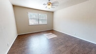 Located at 1200 E Ayers St in Edmond, Oklahoma, this single-story residence offers a practical and comfortable layout with consistent finishes throughout. The living area is generously proportioned, featuring durable wood-look flooring, neutral beige walls, and a ceiling fan with integrated lighting. Natural light filters in through slatted blinds, casting bright patterns across the floor and creating a warm, inviting atmosphere. A front entry door opens directly into this open living space, enhancing the sense of accessibility and flow.

The kitchen is equipped with warm oak cabinetry, granite-style laminate countertops, a black electric range with overhead ventilation, and a dishwasher — providing a fully functional cooking environment. The wood-look flooring continues seamlessly from the main living areas into the kitchen.

The bedrooms offer a change in texture with plush wall-to-wall carpeting, neutral tones, and natural light from windows fitted with blinds. Each room provides a quiet, comfortable retreat. The bathroom features a full tub-shower combination with clean white surrounds, a toilet, a dark wood vanity, and consistent wood-look flooring, delivering a cohesive and tidy finish. Textured ceilings are present throughout, adding a classic residential character to the home.