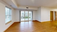 Located at 3020 University Ave SE in Minneapolis, this well-appointed 3-bedroom, 1-bathroom unit offers a thoughtfully designed single-floor layout. The open-concept kitchen and living area serves as the heart of the home, featuring warm wood cabinetry, white countertops, a central island with a stainless steel range hood, and a full suite of stainless steel appliances including a refrigerator, dishwasher, and range. Recessed lighting and light hardwood-style flooring throughout the main areas create a bright, welcoming atmosphere. The spacious living room is bathed in natural light from multiple windows and sliding glass doors that open to a private balcony, offering views of the surrounding neighborhood and greenery. The primary bedroom is generously sized, with large windows framing city and campus views, and features neutral carpet flooring. The two additional bedrooms also offer carpeted floors, ample closet space, and good natural light through wide windows. The full bathroom is finished with warm earth-tone tile on the floors and walls, complemented by a tub/shower combination and a vanity with storage. This unit combines functional design with comfortable living in a prime University District location.