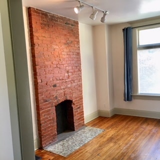 View of living room out into large front window. - 146 W 6th Ave