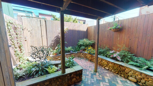 Back garden accessible via backdoor - 608 1/2 Acker Place NE Townhome