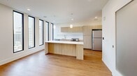 This contemporary 560 square foot apartment, located on the 8th floor of 111 Lyon St NW in Grand Rapids, offers a blend of modern design and urban living. The open-concept layout maximizes the use of space, creating a seamless flow between the living areas. The kitchen is a standout feature, boasting sleek light wood cabinetry, white countertops, and stainless steel appliances. A generously sized island doubles as a dining area and workspace.

Floor-to-ceiling windows flood the space with natural light and provide panoramic city views. The 110 square foot bedroom, while compact, is thoughtfully designed with ample space for a queen-sized bed. The bathroom features clean lines and a modern aesthetic, with a white color palette and chrome fixtures.

Throughout the apartment, warm wood flooring adds a touch of warmth to the otherwise crisp, minimalist design. Recessed lighting and pendant fixtures provide layered illumination. Despite its modest size, the apartment's clever layout and use of light colors create an airy, spacious feel, making it an ideal urban retreat in the heart of Grand Rapids.