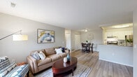 Located at 2000 Elmhurst Circle in Lake Orion, MI, this 2-bedroom, 2-bathroom single-story residence offers a well-organized and functional floor plan with modern finishes throughout. The entryway, featuring a classic paneled front door with a transom window, opens directly into a bright and open living room finished with light wood-style flooring and neutral gray walls. The living area flows seamlessly into the dining space, creating an inviting open-concept feel.

The galley-style kitchen is a standout feature, showcasing white shaker cabinetry, granite countertops, stainless steel appliances including a gas range and refrigerator, a subway tile backsplash, and a deep undermount sink — all contributing to a clean, contemporary aesthetic. A peninsula counter connects the kitchen to the dining area, ideal for casual dining or entertaining.

Both bedrooms are carpeted and comfortably sized, with the primary bedroom offering a spacious walk-in closet equipped with wire shelving and hanging rods. The two bathrooms are finished with white vanities, granite countertops, and wood-style flooring. Additional highlights include five closets throughout, an in-unit laundry area, and a hallway connecting all rooms efficiently. The overall ambiance is bright, clean, and move-in ready.