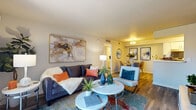 This thoughtfully designed single-floor residence offers a comfortable and cohesive living experience throughout its well-organized layout. The living area is bright and welcoming, featuring wood-look flooring, neutral walls, and a sliding glass door that opens to a private patio, allowing natural light to flow freely into the space. A dedicated media wall provides a clean, modern focal point in the room.

The dining area sits adjacent to the living room, defined by overhead lighting and tasteful wall décor, creating a seamless transition between spaces. The galley-style kitchen is efficiently designed with white cabinetry, stainless steel appliances including a range and refrigerator, a subway tile backsplash, and a built-in pantry offering generous storage capacity.

The residence includes two bedrooms, each with wood-look flooring, natural window light, and a calm, restful atmosphere. The primary bedroom is generously proportioned, while the secondary bedroom is equally well-finished and functional.

Two full bathrooms serve the home. One features a walk-in shower, and the other includes a shower-tub combination, both with white vanities and wood-look tile flooring. The overall design is clean and consistent, with a neutral palette and modern finishes carried throughout the entire residence.