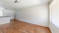 Located at 811 N Alvernon Way in Tucson, Arizona, this one-bedroom, one-bathroom unit offers a well-organized, single-floor layout that makes efficient use of its space. Wood-look flooring runs consistently throughout, lending warmth and visual continuity to every room.

The combined kitchen and living area serves as the heart of the unit. The kitchen is outfitted with dark espresso-toned cabinetry — both upper and lower — paired with light countertops, a white electric range, a double-basin stainless steel sink, and a full-size refrigerator. A window with vertical blinds allows natural light to brighten the cooking space. The adjacent living area features a painted white brick accent wall, a textured ceiling, and a front-facing window with views to the exterior, creating an open and airy feel.

The bedroom is a comfortable, well-proportioned room with the same wood-look flooring, a painted brick wall, and a window dressed with vertical blinds that filters in natural light. It connects directly to a dedicated closet, providing convenient storage.

The bathroom is clean and functional, featuring a full tub-shower combination with white subway tile surround and a window above the tub for added ventilation and light. A hallway connects the living spaces to the private areas of the unit, completing the straightforward and practical floor plan.