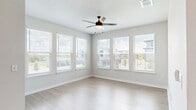 This well-appointed 3-bedroom, 3-bathroom residence in Apopka, Florida offers a thoughtfully designed single-floor layout that balances modern aesthetics with everyday functionality. The open-concept kitchen and living area serves as the heart of the home, featuring a large curved island with a built-in sink, crisp white upper cabinetry, two-tone lower cabinets, a herringbone tile backsplash, stainless steel appliances, and stylish pendant lighting overhead. Light wood-look flooring flows seamlessly throughout the space, enhancing the bright, airy ambiance. The generously sized living room is bathed in natural light through multiple windows fitted with blinds, and includes a ceiling fan for added comfort, with direct access to a private balcony. The spacious primary bedroom offers a comfortable retreat, while additional bedrooms are well-proportioned with natural light and ceiling fans. The bathrooms are finished to a high standard — one features a sleek glass-enclosed walk-in shower with large-format tile, while another includes a full soaking tub with tiled surround and modern black fixtures. White vanities and wood-look flooring complete the clean, contemporary look. A dedicated laundry area with full-size washer and dryer adds practical convenience to this move-in-ready home.