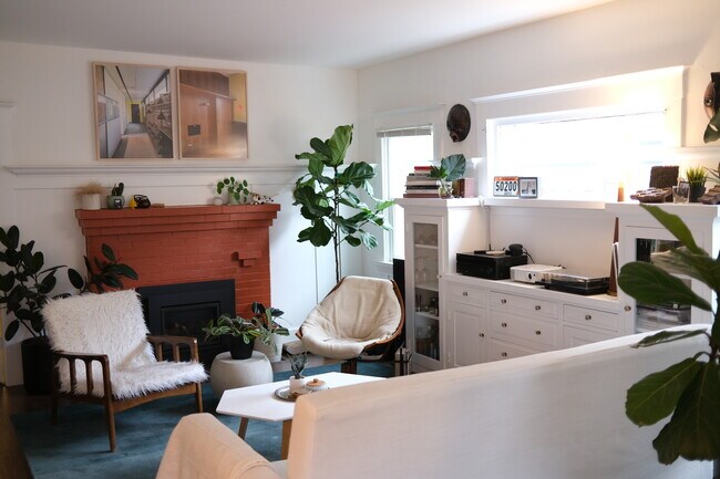 The living room features original built-ins and a gas fireplace. - 877 53rd Street