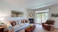 Located at 807 Ridgeview Ct in Sellersville, PA, this well-appointed three-story home offers an expansive and thoughtfully designed layout across its floors. The main level — the heart of the home — features an open-concept dining room, kitchen, and living area with warm hardwood flooring, providing a seamless flow ideal for both everyday living and entertaining. A convenient powder room with a pedestal sink and hardwood floors adds practical elegance to this level. The kitchen is equipped with stainless steel appliances, including a French door refrigerator, complemented by granite countertops.

The upper level houses the two bedrooms, including a primary suite with vaulted ceilings, a ceiling fan, plush carpeting, and natural light from large windows. A walk-in closet with wire shelving provides generous storage. The bathrooms are finished in a clean, neutral palette, with one featuring a soaking tub-shower combination and decorative tilework. A dedicated home office on this level offers recessed lighting and carpeted flooring, ideal for a productive workspace.

The lower level provides a spacious secondary living room with recessed lighting and plush carpet, perfect as a media or recreation room. Utility rooms and additional bathrooms round out the functional layout. Outdoors, mature trees and manicured greenery create a tranquil setting.