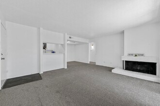 Open floorplan with fireplace and view of the kitchen - Stone Canyon