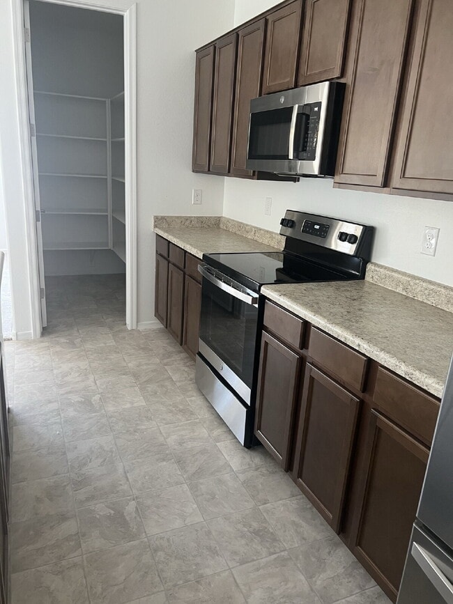 Building Photo - 4 BEDROOM RENTAL WITH 3 CAR GARAGE IN LOS PORTALES CASA GRANDE ARIZONA