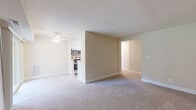 Located at 2 Sunny Meadow Ct in Baltimore, MD, this single-floor, one-bedroom, one-bathroom residence offers a practical and well-appointed layout. The open-concept living and dining area is bright and welcoming, with neutral carpet flooring, a ceiling fan with light fixture, and a sliding glass door that fills the space with natural light and provides views of the surrounding greenery. The kitchen is thoughtfully designed in a galley style, featuring crisp white cabinetry, granite-look countertops, light hardwood-style flooring, and a full suite of stainless steel appliances including a refrigerator, dishwasher, gas range, and microwave. A pass-through opening connects the kitchen to the main living area, enhancing the sense of openness. The generously sized bedroom includes soft carpet flooring, a window overlooking the outdoors, and a dedicated closet with bifold doors providing ample storage. An additional closet is accessible from the hallway. The bathroom features a full soaking tub with a striking marble-look surround in white and grey tones, lending an elegant and clean aesthetic. The overall palette of warm neutrals and white trim creates a cohesive, move-in-ready atmosphere throughout the home.