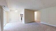 Located at 2 Sunny Meadow Ct in Baltimore, MD, this single-floor, one-bedroom, one-bathroom residence offers a practical and well-appointed layout. The open-concept living and dining area is bright and welcoming, with neutral carpet flooring, a ceiling fan with light fixture, and a sliding glass door that fills the space with natural light and provides views of the surrounding greenery. The kitchen is thoughtfully designed in a galley style, featuring crisp white cabinetry, granite-look countertops, light hardwood-style flooring, and a full suite of stainless steel appliances including a refrigerator, dishwasher, gas range, and microwave. A pass-through opening connects the kitchen to the main living area, enhancing the sense of openness. The generously sized bedroom includes soft carpet flooring, a window overlooking the outdoors, and a dedicated closet with bifold doors providing ample storage. An additional closet is accessible from the hallway. The bathroom features a full soaking tub with a striking marble-look surround in white and grey tones, lending an elegant and clean aesthetic. The overall palette of warm neutrals and white trim creates a cohesive, move-in-ready atmosphere throughout the home.