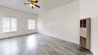 Located at 323 E Lomita Ave in Glendale, California, this single-story 1-bedroom, 2-bathroom unit offers a clean, modern layout with a cohesive design throughout. Light gray wood-look flooring runs continuously across all rooms, lending a sense of visual openness and consistency.

The living room is bright and airy, featuring white-shuttered windows that allow generous natural light to fill the space, complemented by a ceiling fan with a light fixture. The open feel flows into the kitchen, which is equipped with white cabinetry, a gas range, a stainless steel refrigerator, a sink with a contemporary faucet, and track lighting above — offering a functional and well-appointed cooking space.

The bedroom accommodates comfortable living with windows fitted with white plantation shutters and easy access to the closet area. The closet space includes a built-in white dresser with drawers and a wall-mounted mirror, providing practical storage and a vanity area. A sliding closet door adds additional storage capacity.

Two full bathrooms serve the unit, one of which features a full bathtub with white tile surround and chrome fixtures. Throughout the unit, crisp white walls and clean baseboards reinforce the bright, move-in-ready aesthetic of this efficiently designed Glendale residence.