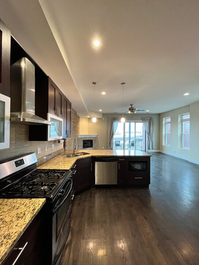 Open Concept with spacious kitchen, living and dining room with skyline views! - 1359 N Noble St