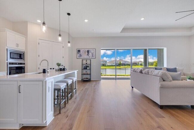 Building Photo - Waterfront Luxury in Isles of Lake Nona | 3-Car Garage, Resort Amenities & HOA-Included Cable, In...