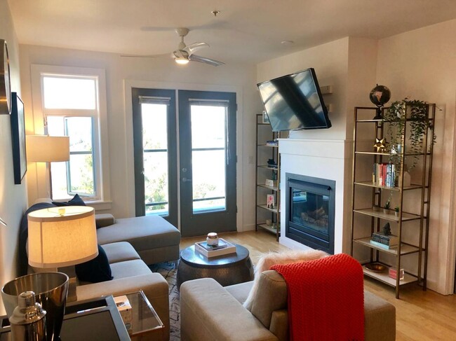 Living room with cozy fireplace and views of Lake Union - 655 Crockett St